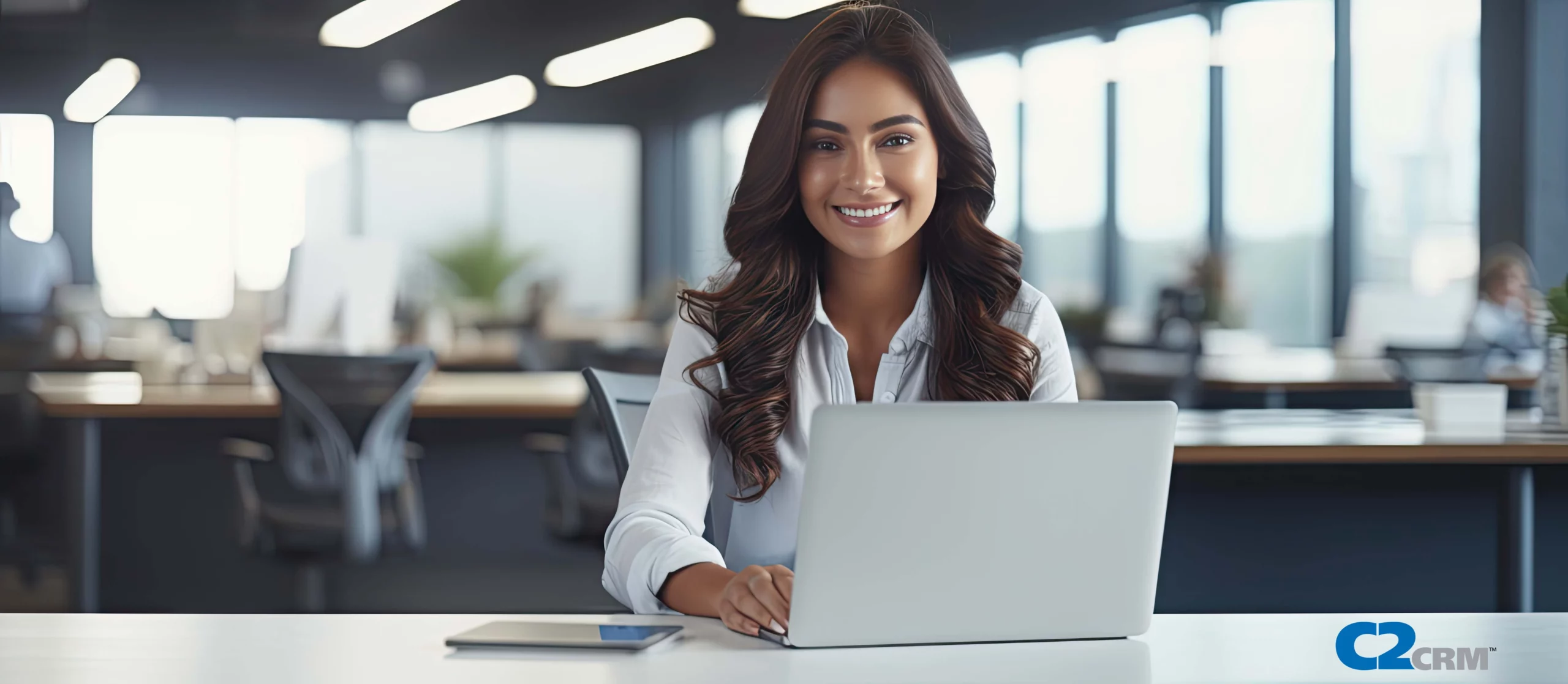 lady smiling using C2CRM on laptop